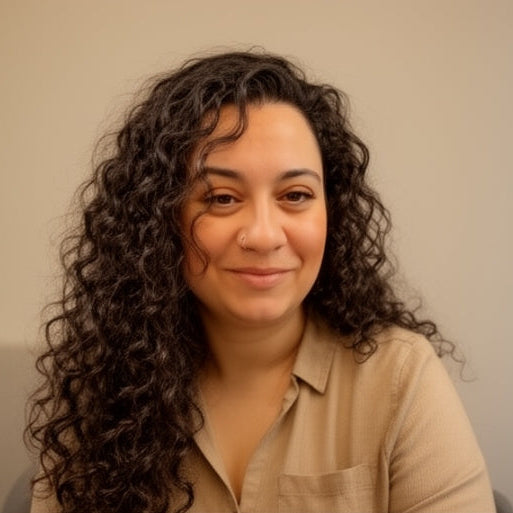 Image of Bahar, a women with curly hair wearing a beige shirt against a plain background